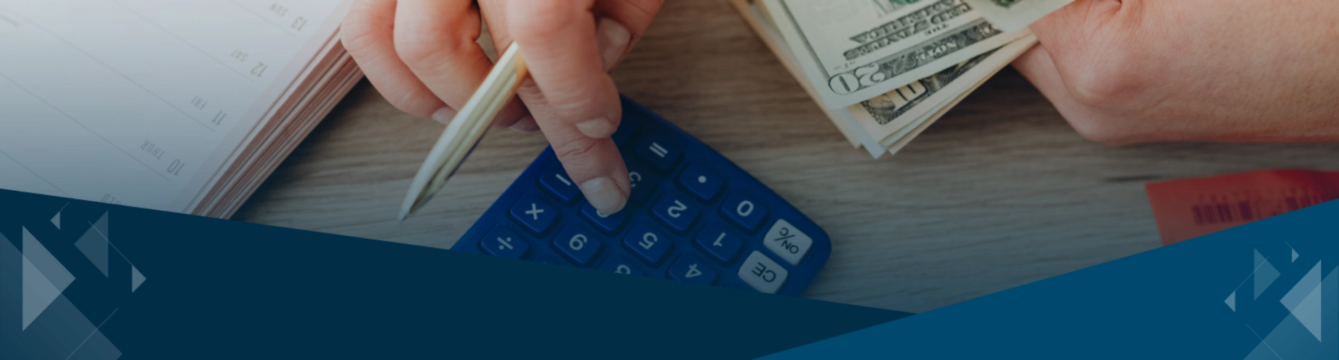 Hand pressing calculator buttons while counting cash for expense tracking